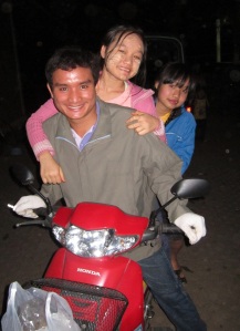 Stle Lin Shwe and his sisters Neh Blu Htoo and Hser Nay Say on a motorbike (before the accident). The girls were not riding when the accident happened.